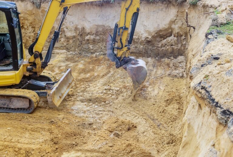 Excavator during earthworks backhoe on work digs ground during earthworks for the foundation